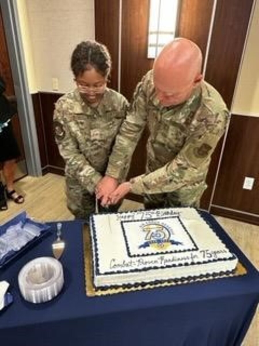 Photo of Maj. Gen. Richard Kemble and Senior Airman Nia Glover cutting a 75th anniversary cake.