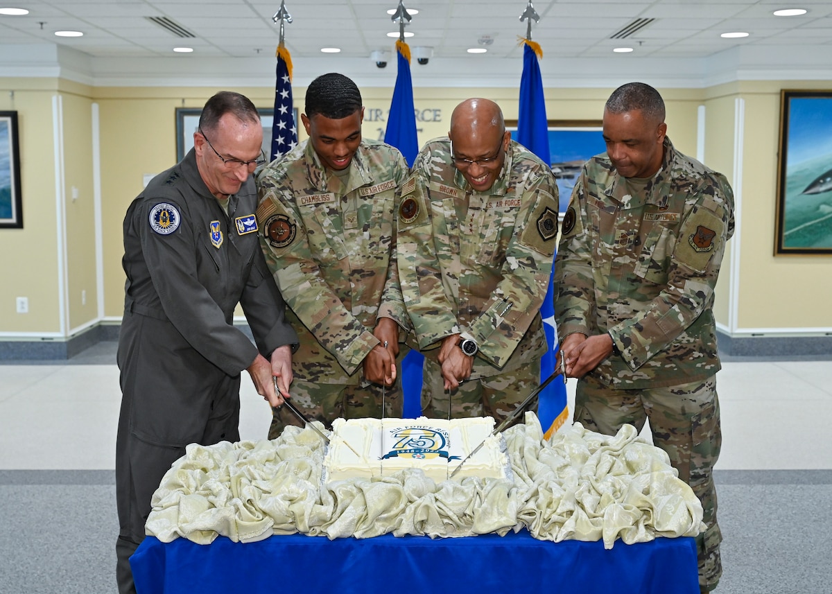 photo of Chief of Air Force Reserve Lt. Gen. John Healy, left, Senior Airman Shamadre Chambliss, the youngest airman present, Air Force Chief of Staff Gen. CQ Brown, Jr. and Chief Master Sgt. Tim White, command chief of Air Force Reserve Command, cut the cake