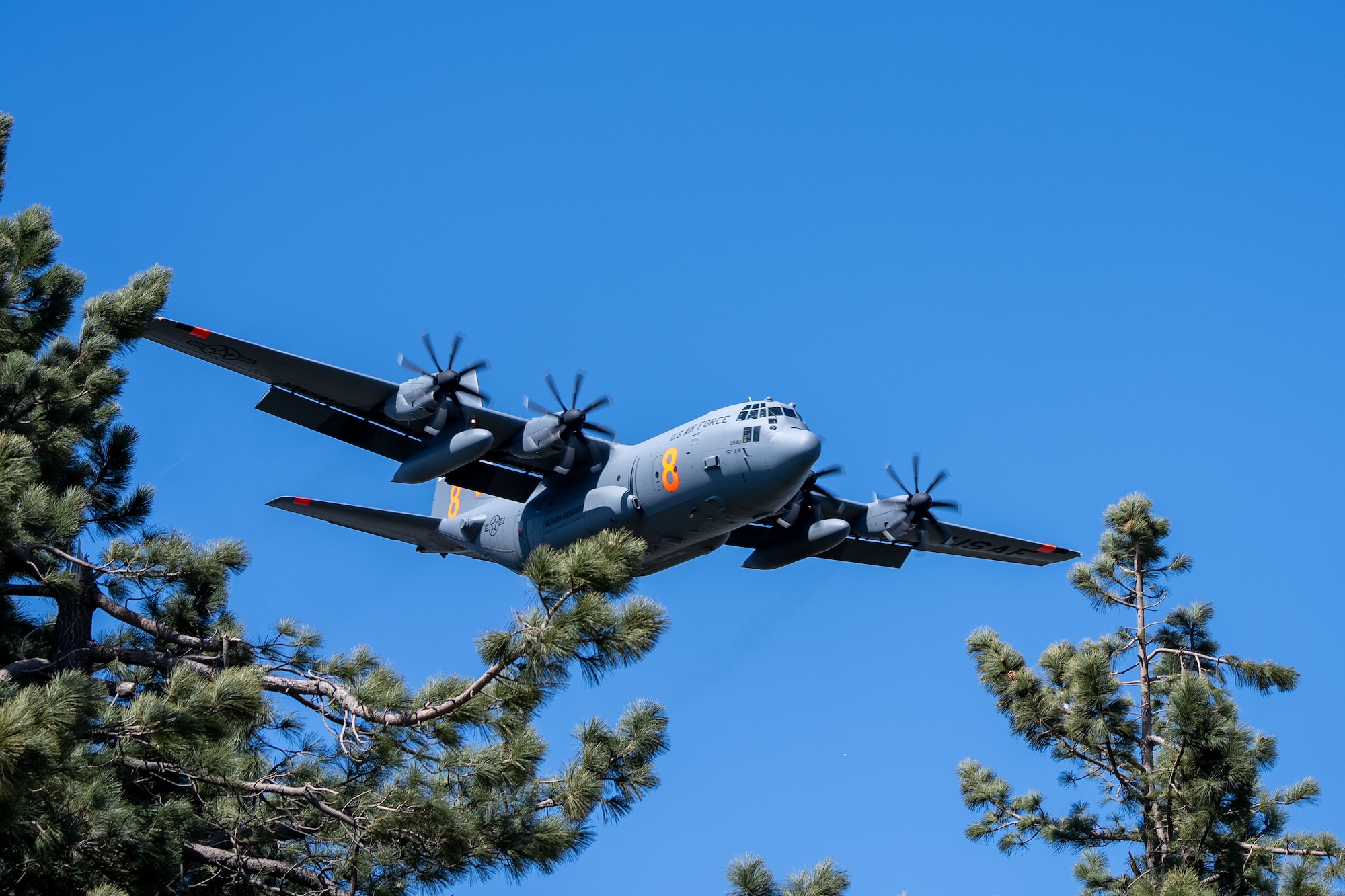 A C-130 (MAFFS 8) from Nevada Air National Guard's 152nd Airlift Wing lines up before performing a water drop April 14, 2023, during Modular Airborne Fire Fighting System spring training hosted by the California Air National Guard's 146th Airlift Wing. The training was conducted in the Angeles National Forest near Green Valley, California, April 11-15.