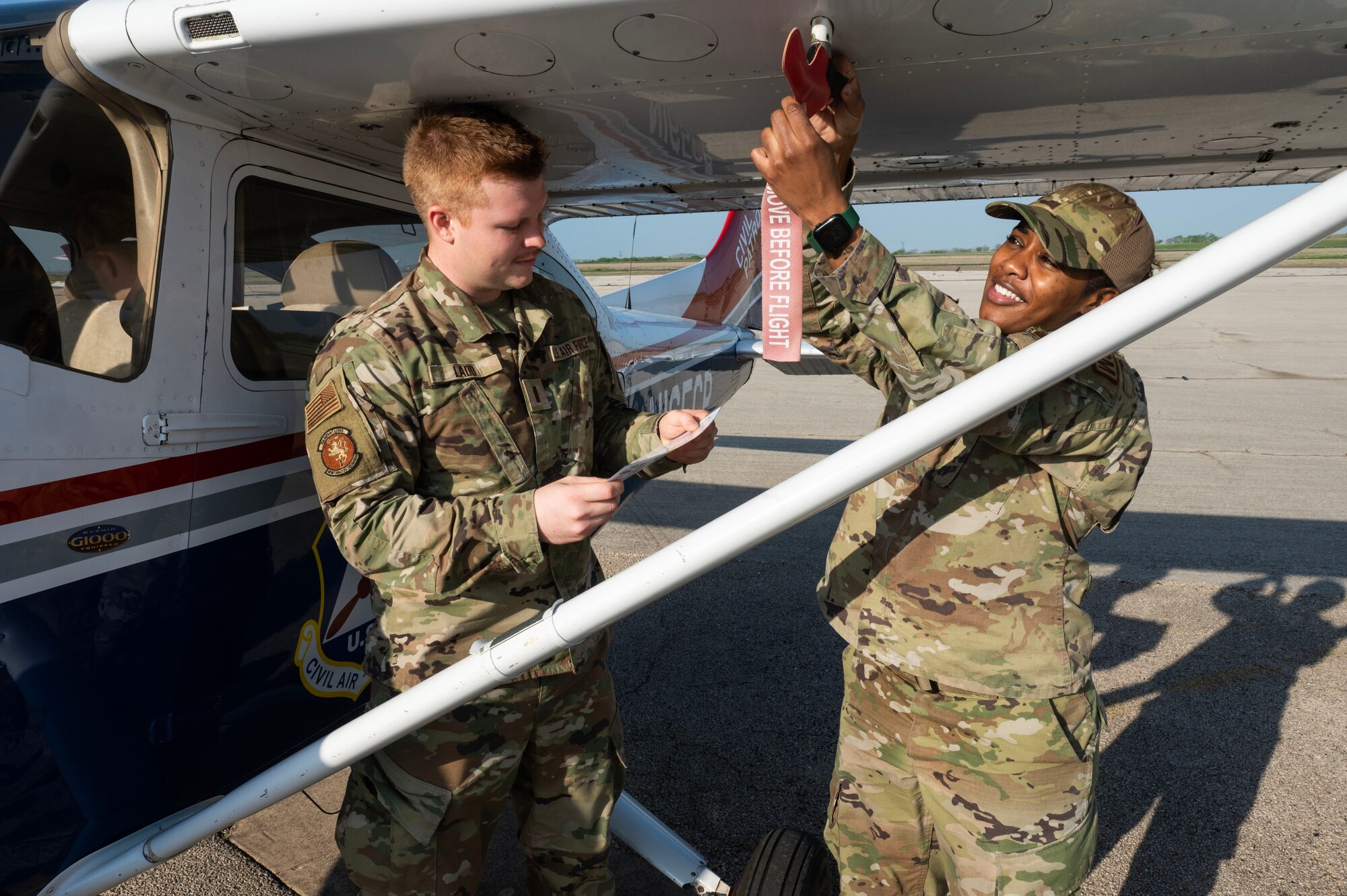 2nd Lt. Matthew Ladd (left) and Master Sgt. Careen Lewis (right), 7th Equipment Maintenance Squadron fabrication flight superintendent, perform pre-flight checks and remove pins on a Cessna 182T aircraft
