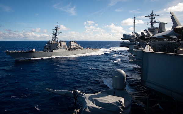 The Arleigh Burke-Class guided-missile destroyer USS Stethem (DDG 63) preforms a break away from the Nimitz-class aircraft carrier USS Carl Vinson (CVN 70) following a fueling-at-sea.