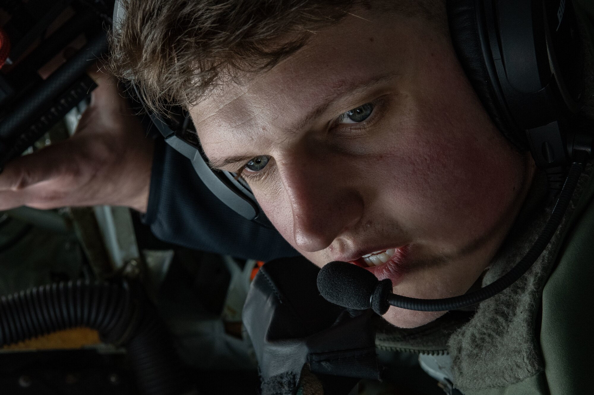 U.S. Air Force Airman 1st Class Max Richards, 351st Air Refueling Squadron boom operator, explains air refueling to local media during a media flight over England