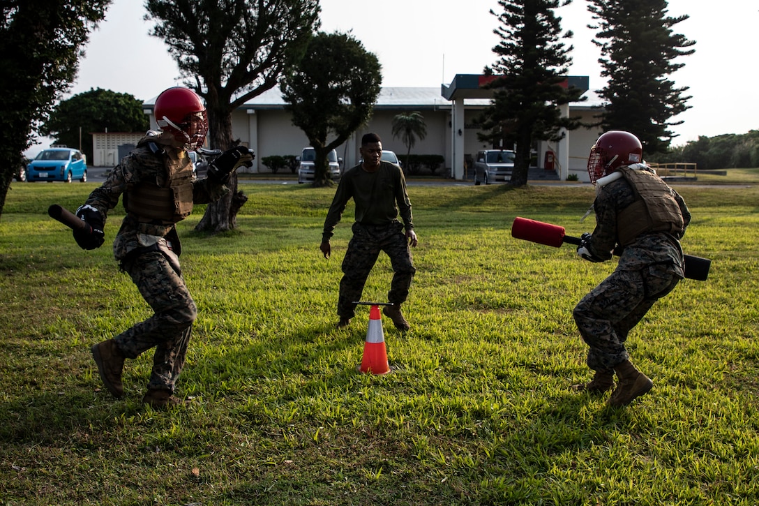 U.S. Marines with III Marine Expeditionary Force, fight using a baton and pugil stick during the culminating event of a III MEF Marine Corps Martial Arts Instructor course on Camp Courtney, Okinawa, Japan, April 13, 2023. The intense three-week long MAI course tests the individual Marine’s physical endurance, character development, and mental fortitude, while teaching them how to train and lead Marine Corps Martial Arts Program belt advancements.