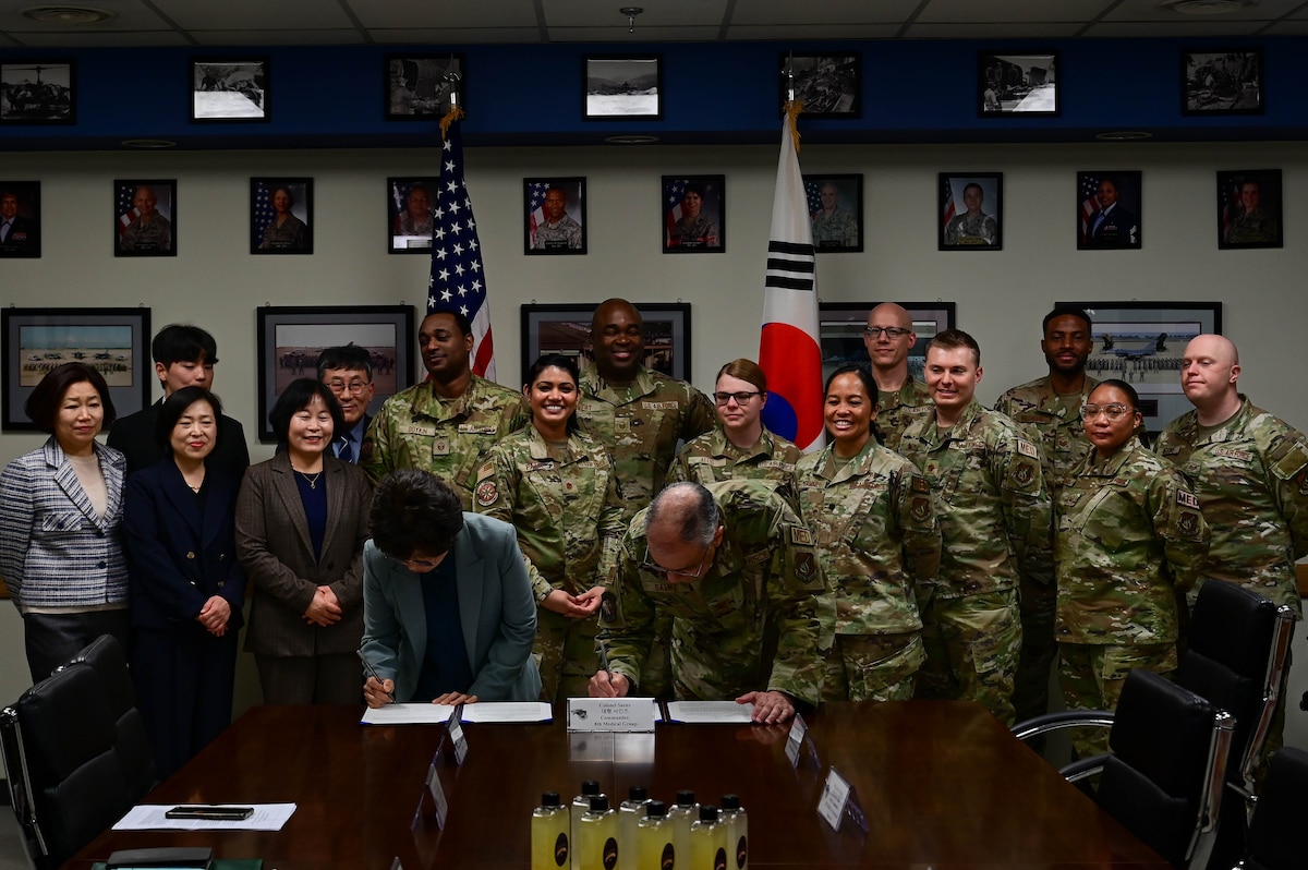 Ms. Sung Nak Yong (left), Gunsan Public Health head and Dr. (Col.) Rene “Hawk” Saenz (right), 8th Medical Group commander, signs a memorandum of understanding (MoU) at Kunsan Air Base, Republic of Korea, Mar. 30, 2023.