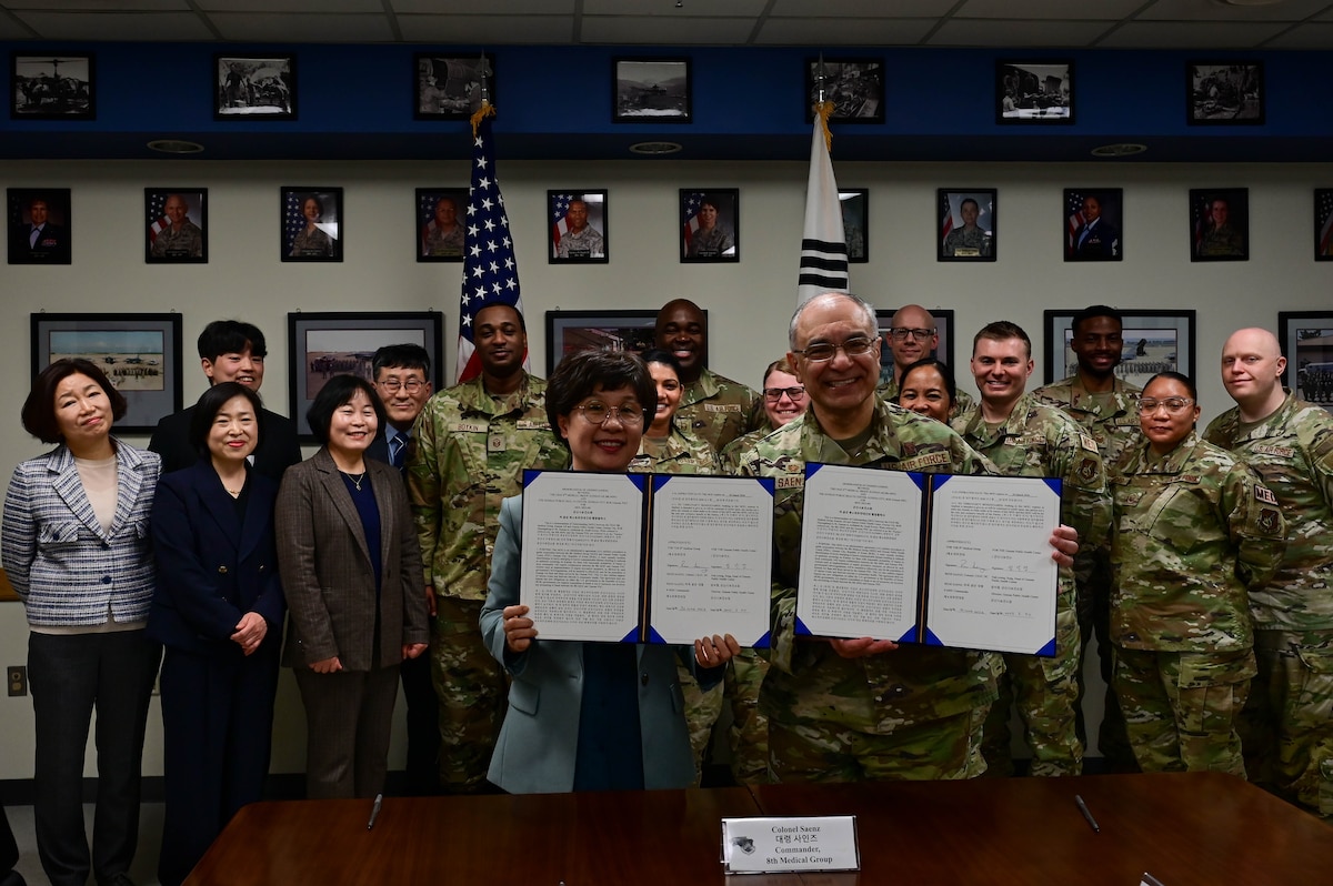 Ms. Sung Nak Yong (left), Gunsan Public Health head, and Dr. (Col.) Rene “Hawk” Saenz (right), 8th Medical Group commander, hold a freshly signed memorandum of understanding (MoU) at Kunsan Air Base, Republic of Korea, Mar. 30, 2023.