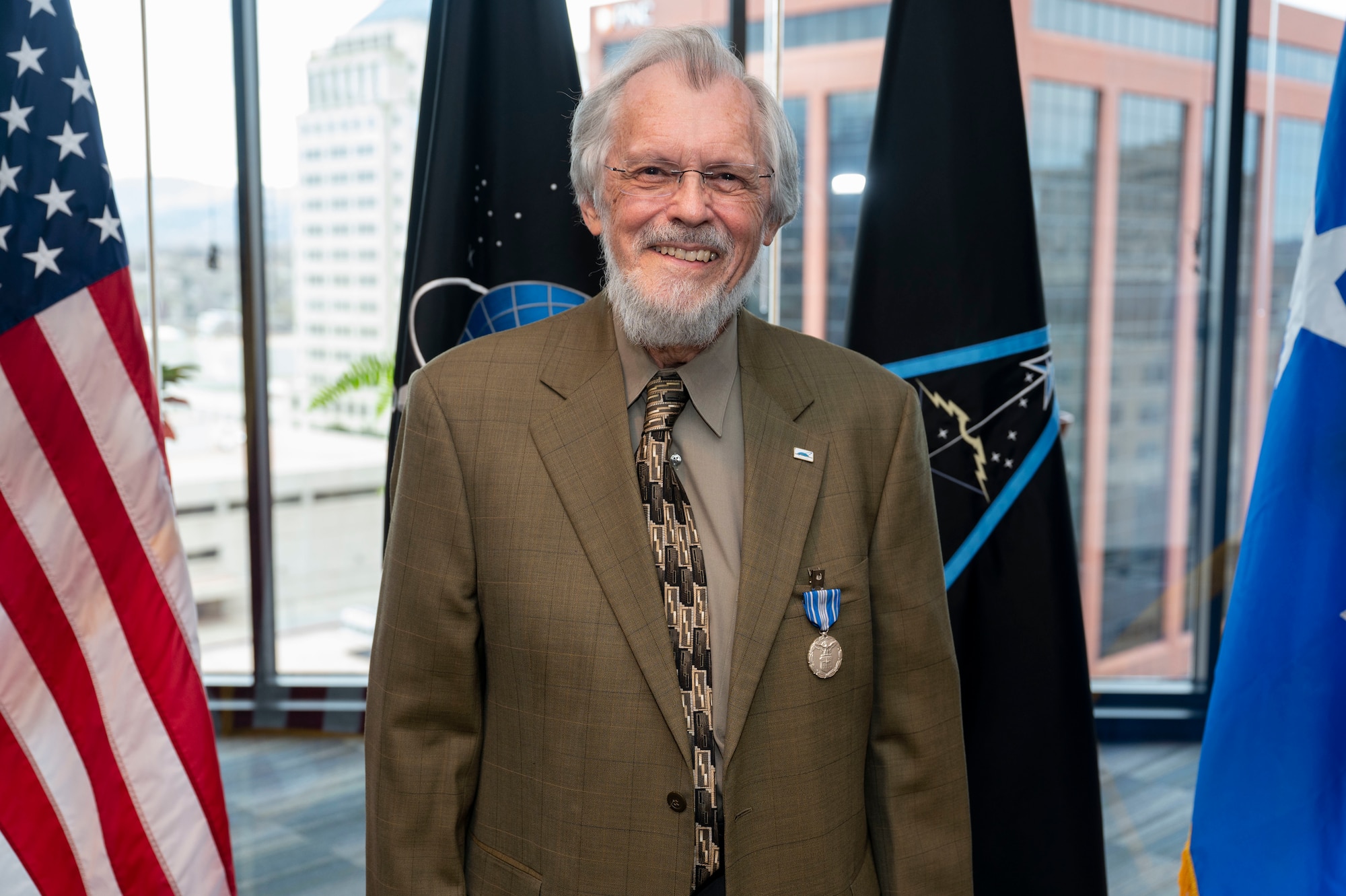 Dr. Rick Sturdevant, Space Training and Readiness Command historian, poses for a photo following a ceremony where he was  presented the American Astronautical Society President's Award for his work as series editor for the International Academy of Astronautics History at STARCOM Headquarters
