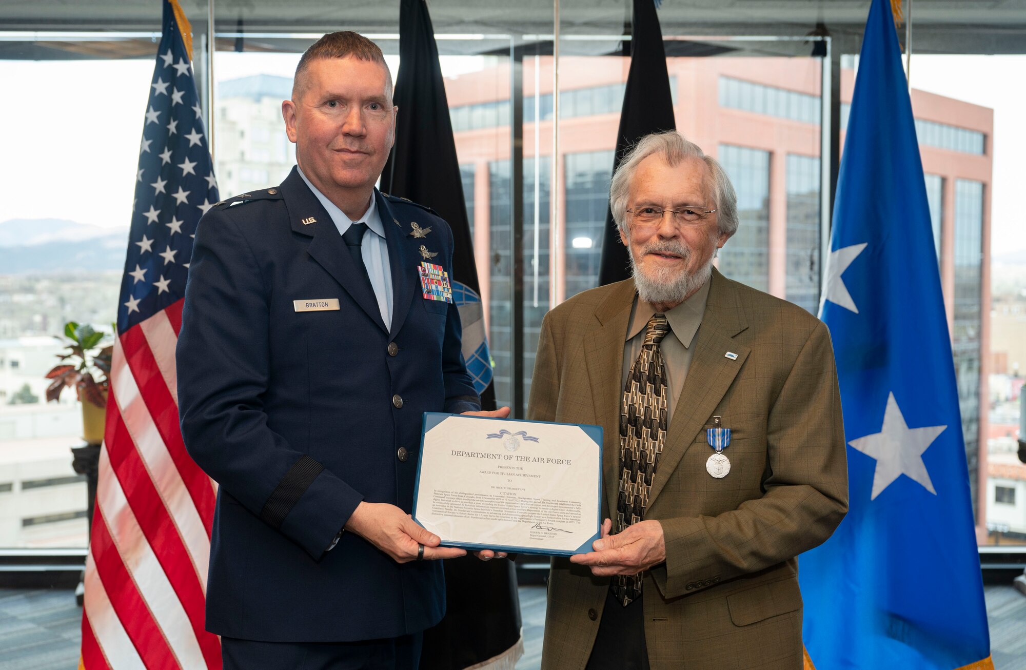 Maj. Gen. Shawn Bratton, Space Training and Readiness Command commander, presents Dr. Rick Sturdevant, STARCOM historian, the Air Force Civilian Achievement Award during a ceremony at STARCOM Headquarters