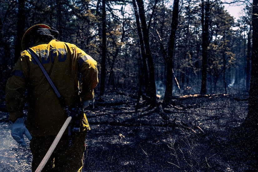 A photo of Joint Base McGuire-Dix-Lakehurst firefighters doing the mop-up phase of a major wildfire.