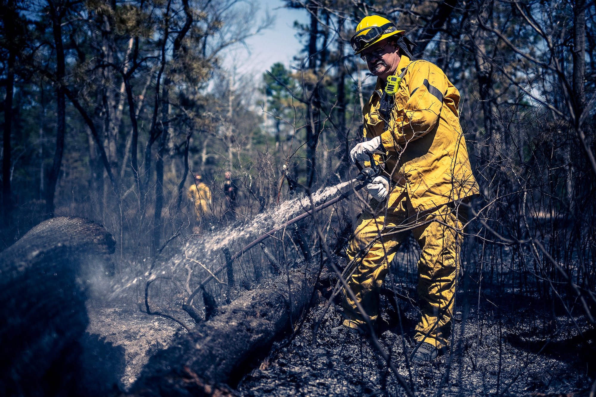 A photo of Joint Base McGuire-Dix-Lakehurst firefighters doing the mop-up phase of a major wildfire.