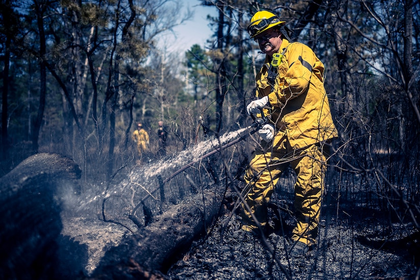 A photo of Joint Base McGuire-Dix-Lakehurst firefighters doing the mop-up phase of a major wildfire.