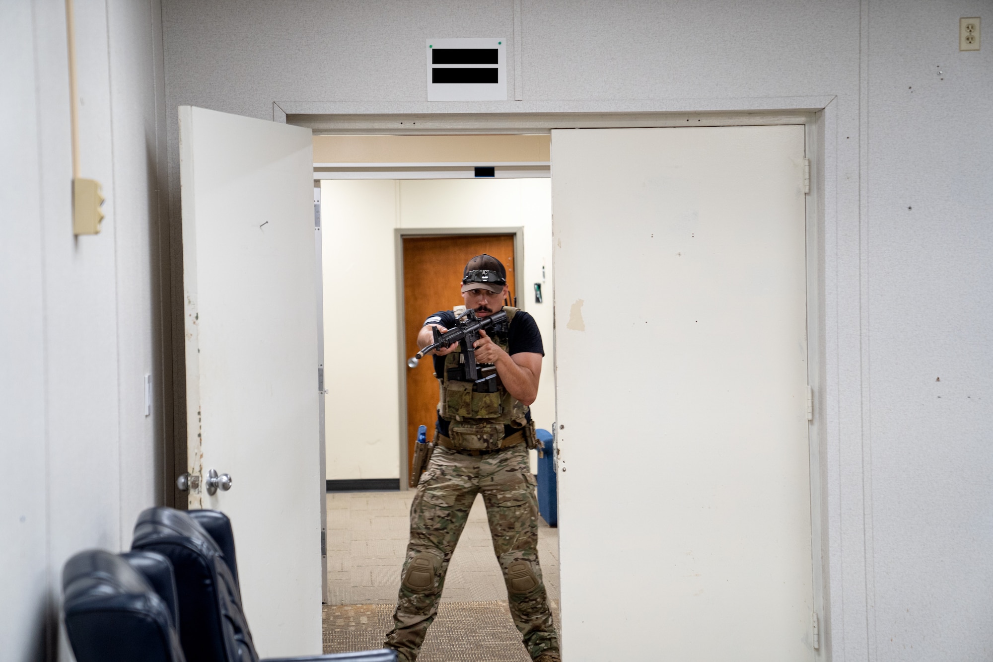 U.S. Air Force Staff Sgt. Michael Dazzo, 5th Combat Communications Support Squadron Combat Readiness lead instructor, demonstrates how to clear a room for members of the 85th Engineering Installation Squadron using close quarter battle tactics during a MOB school course at Keesler Air Force Base, Mississippi, April 12, 2023. In this course 85th EIS students learn weapons familiarization, combatives and other pre-deployment tactics.