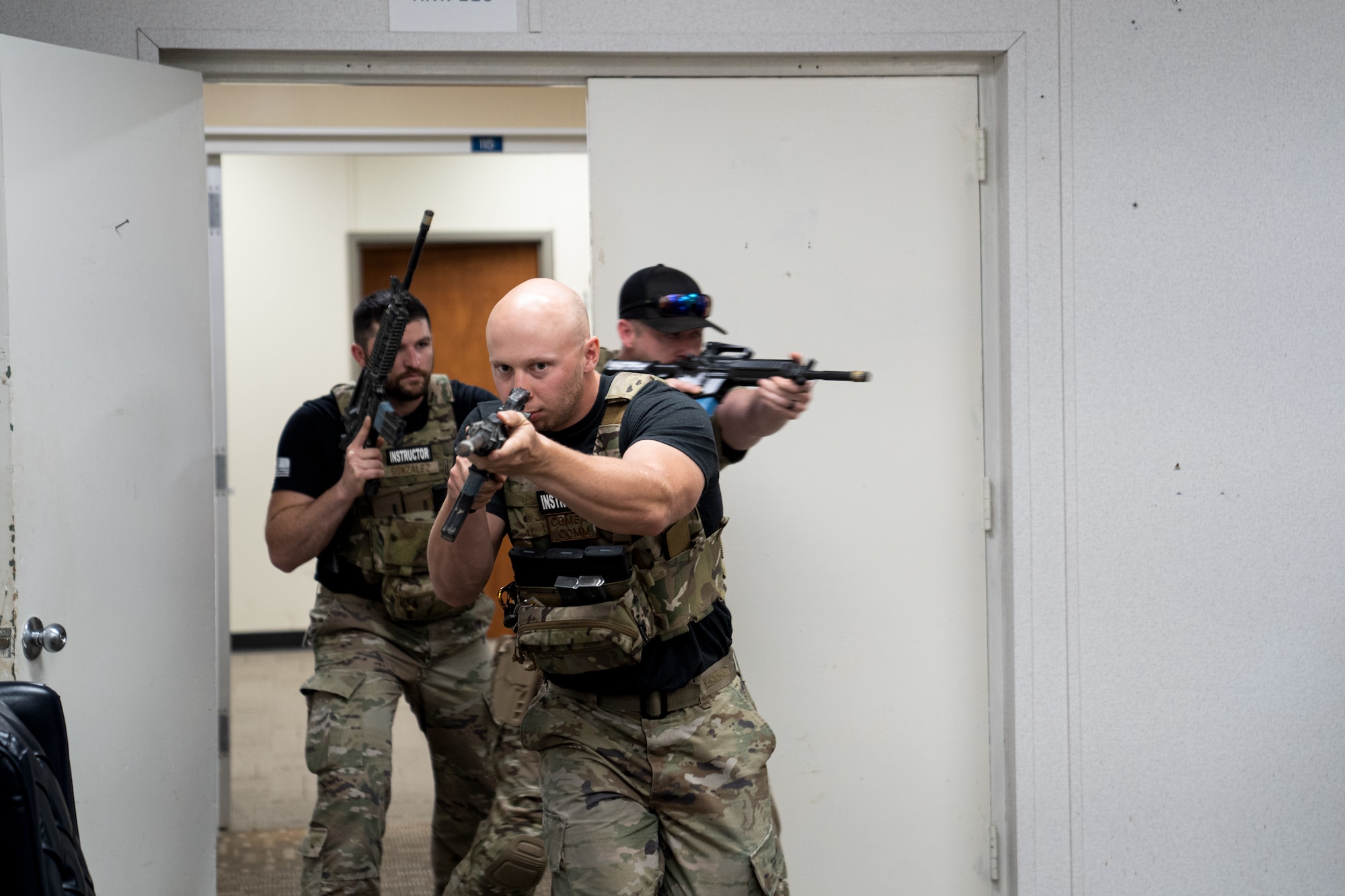 Instructors from the 5th Combat Communications Support Squadron Combat Readiness demonstrate how to clear a room for members of the 85th Engineering Installation Squadron using close quarter battle tactics during a MOB school course at Keesler Air Force Base, Mississippi, April 12, 2023.