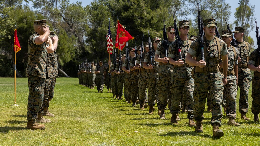 U.S. Marines with Combat Logistics Battalion 11, Combat Logistics Regiment 17, 1st Marine Logistics Group, conduct a pass and review during a change of command ceremony on Camp Pendleton, California, May 18, 2022. Lt. Col. Kathryn E. Wagner relinquished her post to Lt. Col. Robert J. Hillery as the commanding officer for CLB-11. (U.S. Marine Corps photo by Lance Cpl. Casandra Lamas)