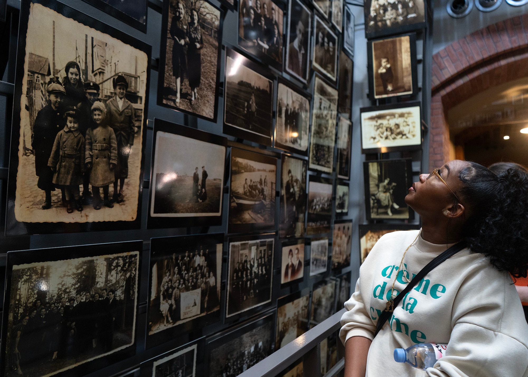 U.S. Air Force Staff Sgt. Sasha Hammons, 707th Communications Squadron assignments noncommissioned officer in charge, views photos on the “Tower of Faces” at the U.S. Holocaust Memorial Museum, Washington D.C., April 17, 2023. Airmen gained insight of what life was like for Jewish people before, during and after World War II, providing a unique experience tailored to informing them of the details surrounding the Holocaust. (U.S. Air Force photo by Staff Sgt. Kevin Iinuma)