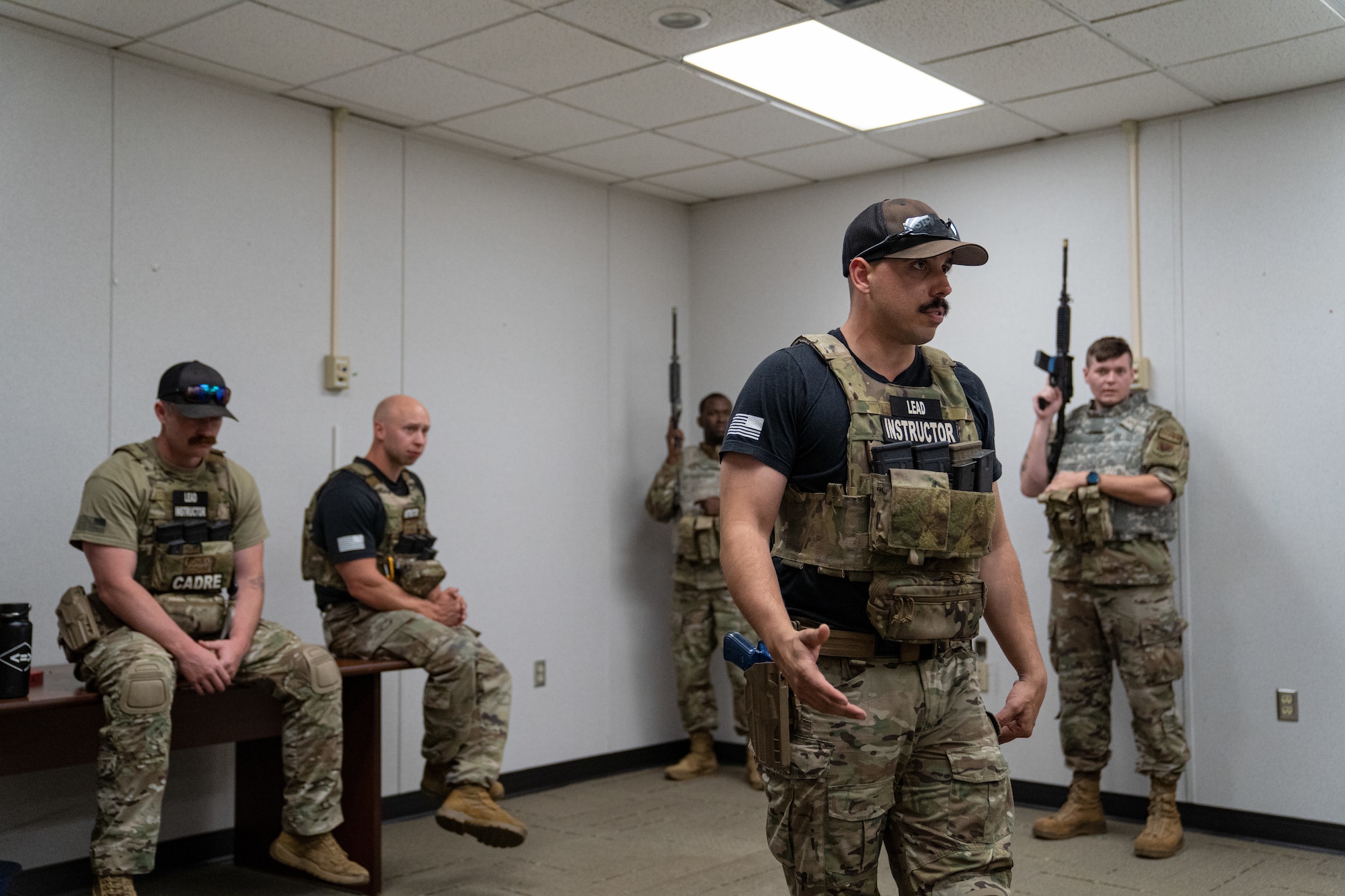 U.S. Air Force Staff Sgt. Michael Dazzo, 5th Combat Communication Support Squadron Combat Readiness lead instructor, gives direction to members of the 85th Engineering Installation Squadron on close quarter battle tactics during MOB school course at Keesler Air Force Base, Mississippi, April 12, 2023. In this course 85th EIS students learn weapons filmization, combative, and other pre deployment tactics.