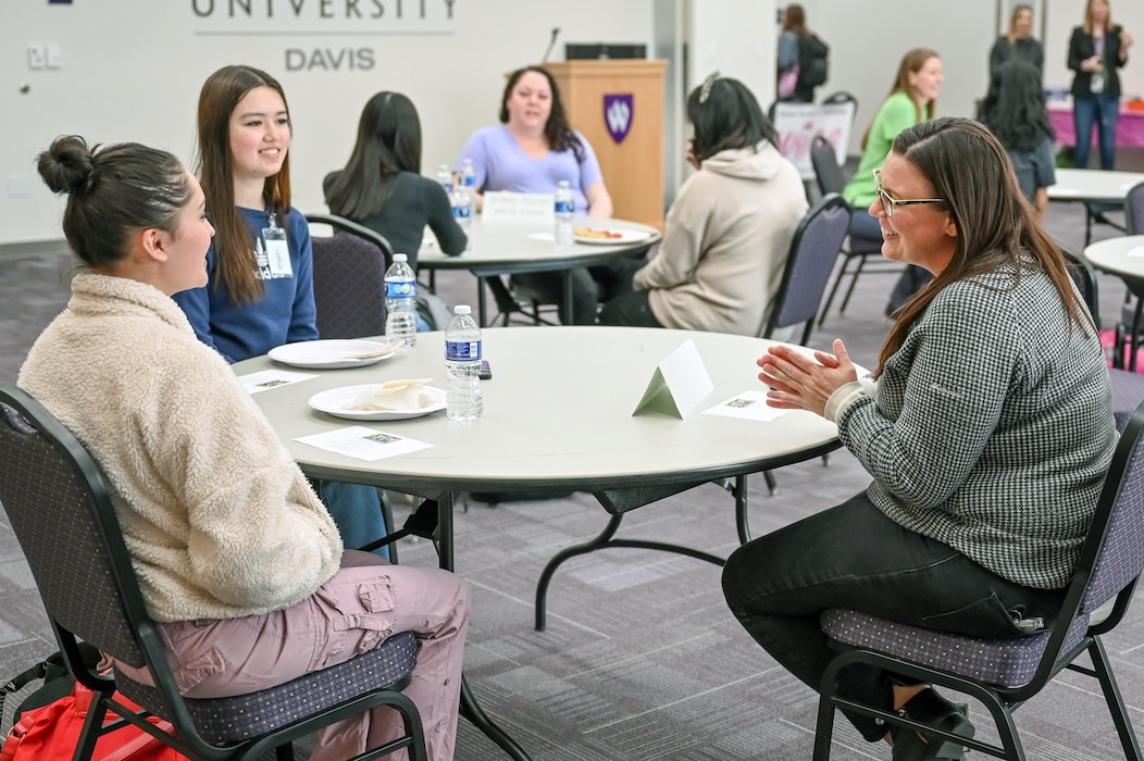 Volunteer meets with female high school students