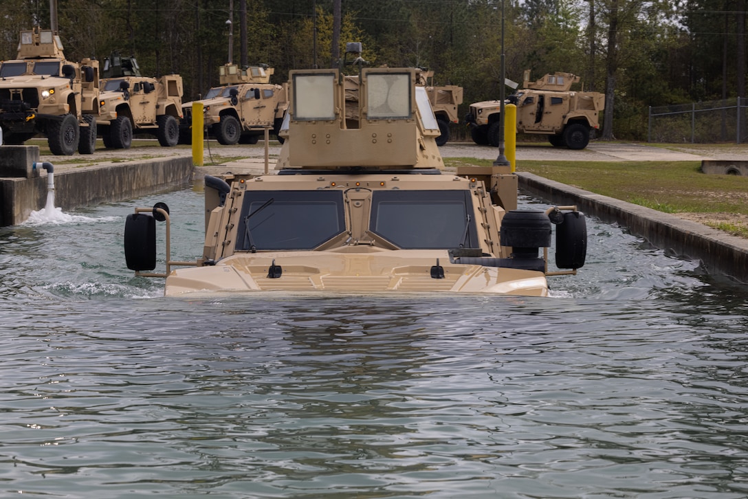 U.S. Marines 6th Marine Regiment, 2d Marine Division conduct a fording operation during the Light Tactical Family (LTF) Crew Maneuver Course on Camp Johnson, North Carolina, April 4, 2023. The five-day course focused on training and educating crew members on effective LTF employment in rough terrains. (U.S. Marine Corps photo by Lance Cpl. Joshua Kumakaw)