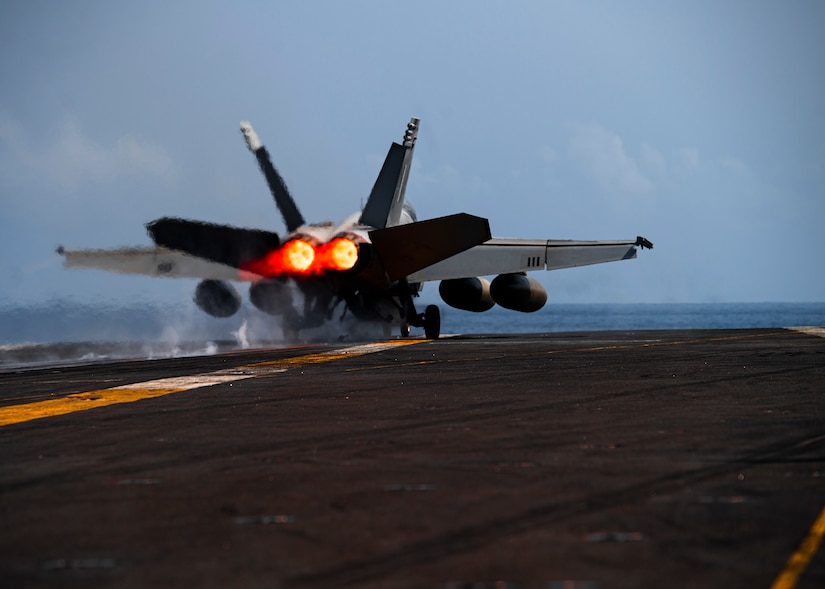 A jet takes off from a carrier.