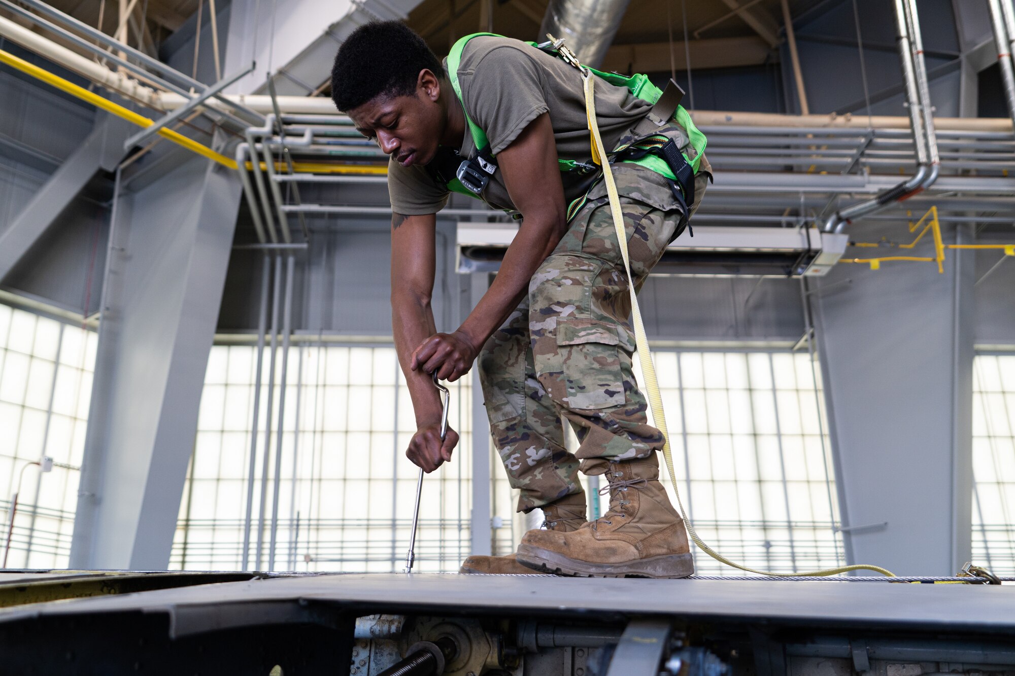 Airman works on the wing of a KC-135 during periodic inspection.
