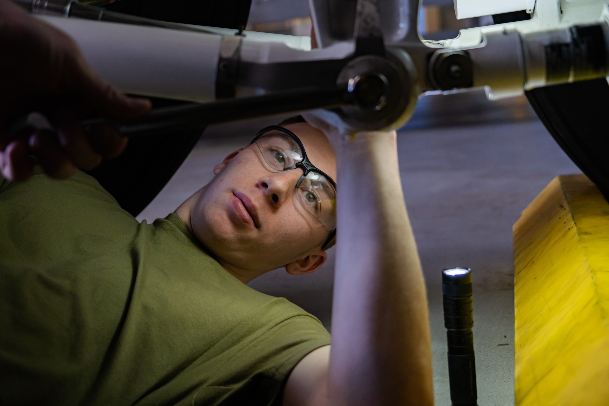 Airman works on components to KC-135 front landing gear