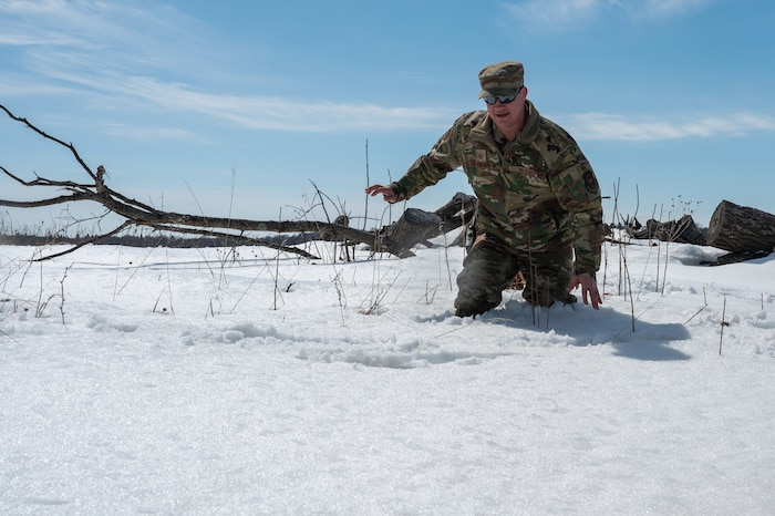 Master Sgt. Jeffrey Letourneau, a 934th Civil Engineering Squadron structural lead, trudges through deep snow at Camp Ripley, Minnesota, on April 2, 2023. The 934 CES conducted a field training exercise, including land navigation and general tent setup. (U.S. Air Force photo by Senior Airman Matthew Reisdorf)