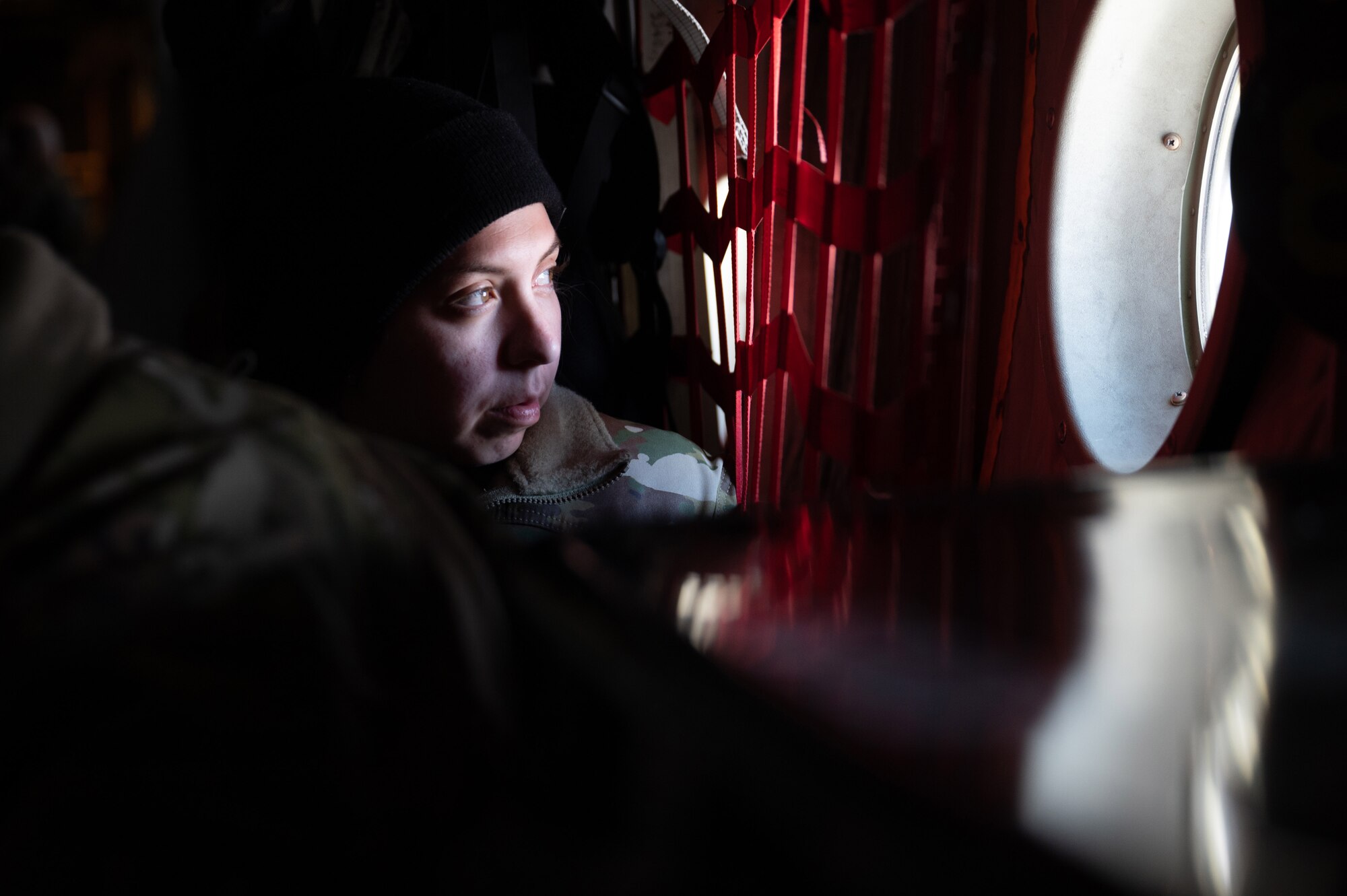 Tech Sgt. Ariana Hassel, a 934th Civil Engineering Squadron engineering assistant, looks out the window of a C-130 midflight en route to Camp Ripley, Minnesota, on April 2, 2023. The 934 CES conducted a field training exercise, including land navigation and general tent setup. (U.S. Air Force photo by Senior Airman Matthew Reisdorf)