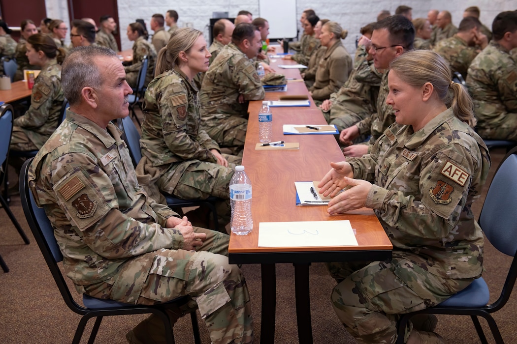 U.S. Air Force Chief Master Sgt. Brian Carroll, the command chief of the Wisconsin Air National Guard's 115th Fighter Wing engages in a speed mentoring session with Staff Sgt. Christina Clark-Mata.