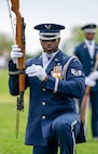 Staff Sgt. Marcus Hardy of the U.S. Air Force Honor Guard Drill Team kneels with his rifle during a performance at the Joint Services Drill Exhibition, April 14, 2023, Washington Monument, Washington, D.C. The Drill Team is an elite unit of 25 Airmen who train, on average, five days a week for eight to ten hours per day to obtain their level of mastery. (U.S. Air Force photo by 2nd Lt. Brandon DeBlanc)
