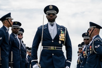 U.S. Air Force Capt. Brian Johnson of the U.S. Air Force Honor Guard Drill Team completes the gauntlet during a performance at the Joint Services Drill Exhibition, April 14, 2023, Washington Monument, Washington, D.C. The Drill Team is an elite unit of 25 Airmen who train, on average, five days a week for eight to ten hours per day to obtain their level of mastery. (U.S. Air Force photo by Kristen Wong)