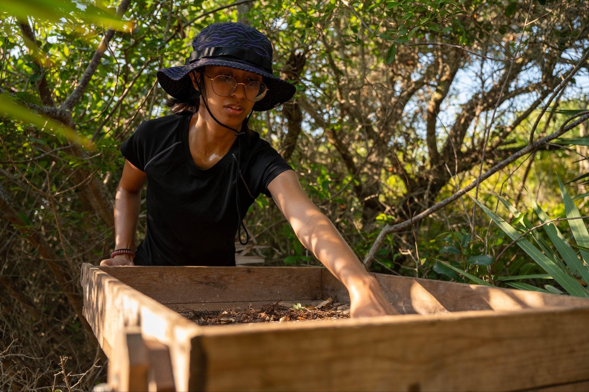 Danielle Delacruz, Department of Anthropology student at University of Central Florida, sifts through dirt from dig sites for potential artifacts April 5, 2023, at Cape Canaveral Space Force Station, Fla. The artifacts uncovered from these dig sites range from 500 B.C. - A.D. 1565. (U.S. Space Force photo by Senior Airman Samuel Becker)