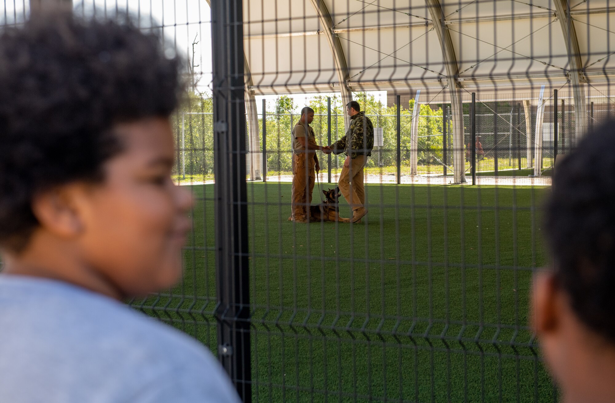 Children watch a military working dog demonstration