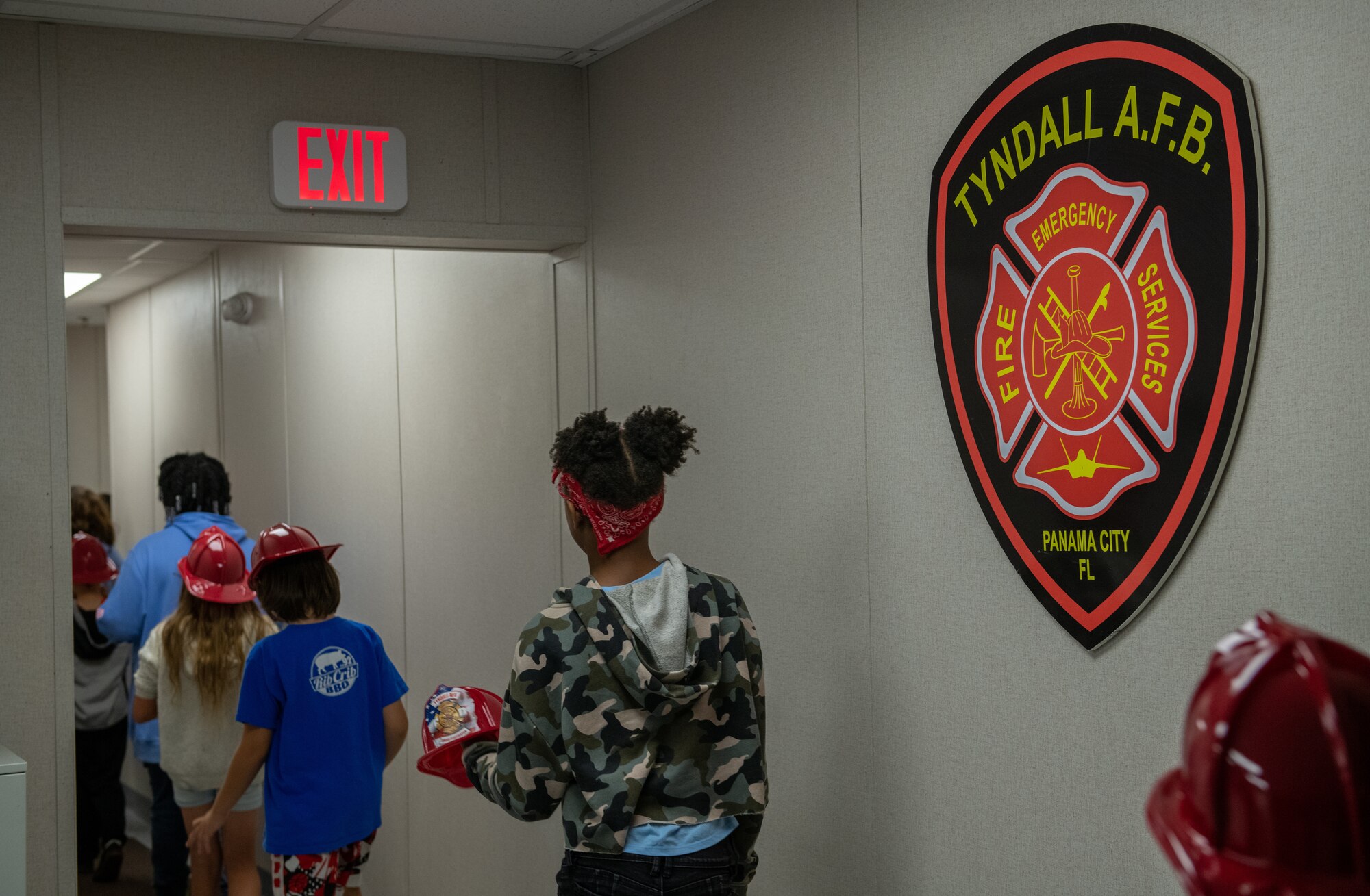 Children walk through the halls of a fire station