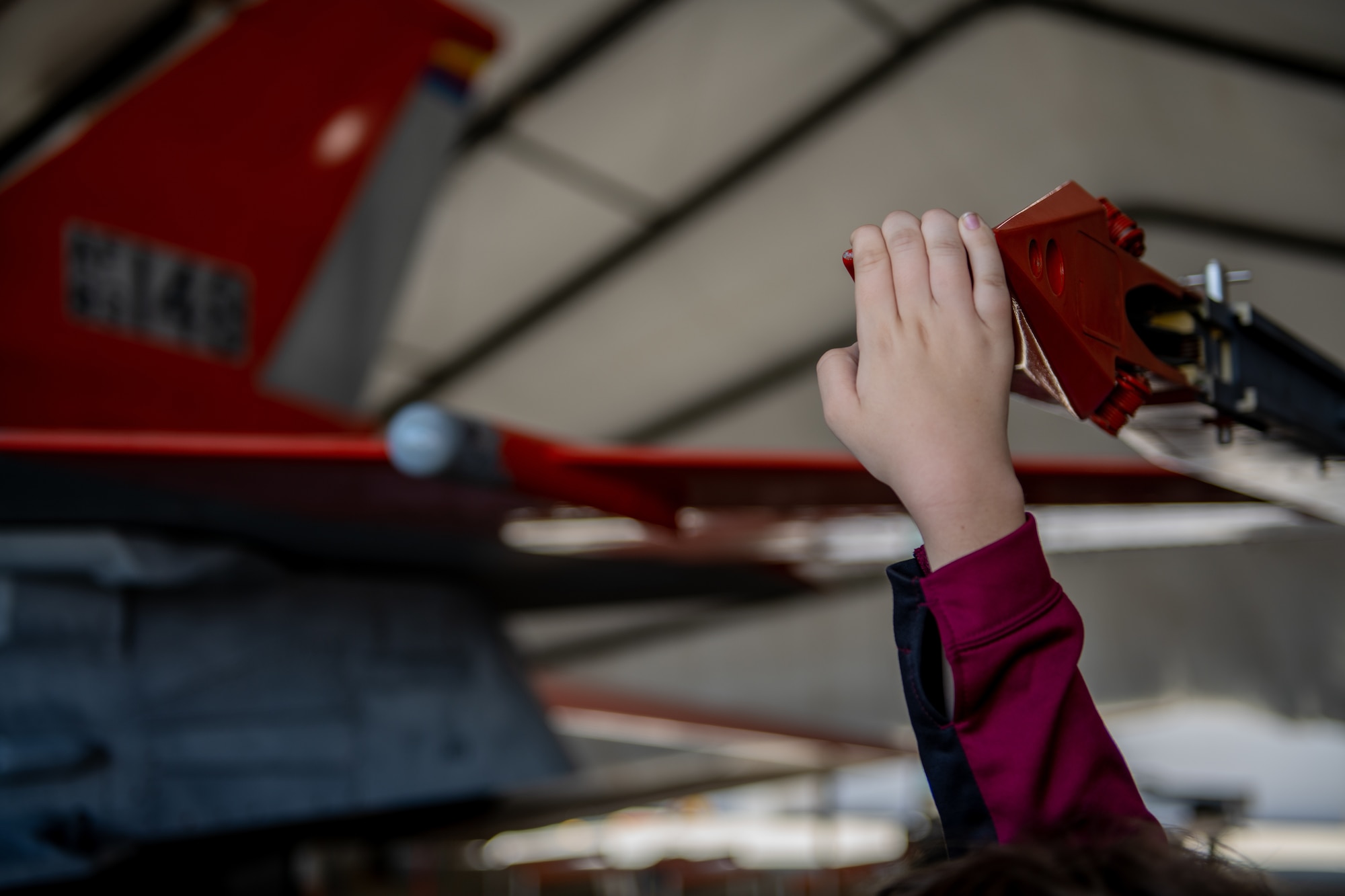 A child holds onto the wing of an aircraft
