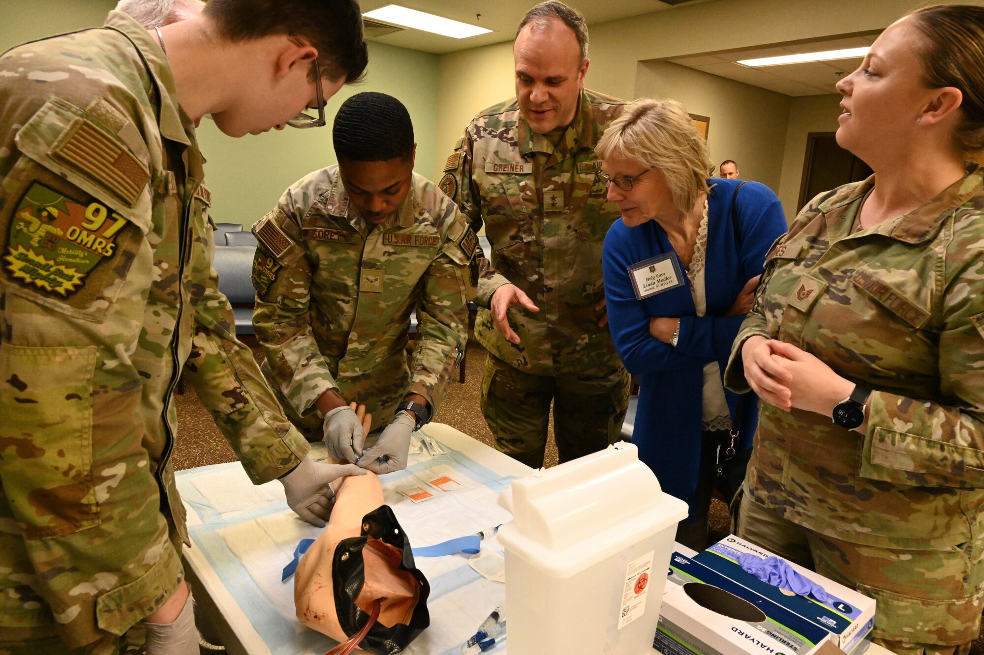 Members of the 97th Operational Medical Readiness Squadron demonstrate tactical combat casualty care to former 97 Air Mobility Wing leaders during the “Legacy of the Spear” event at Altus Air Force Base (AAFB), April 14, 2023. The 97th Medical Group provides critical healthcare operations to Altus AFB Airmen, retirees, and their families. (U.S. Air Force photo by Airman 1st Class Miyah Gray)