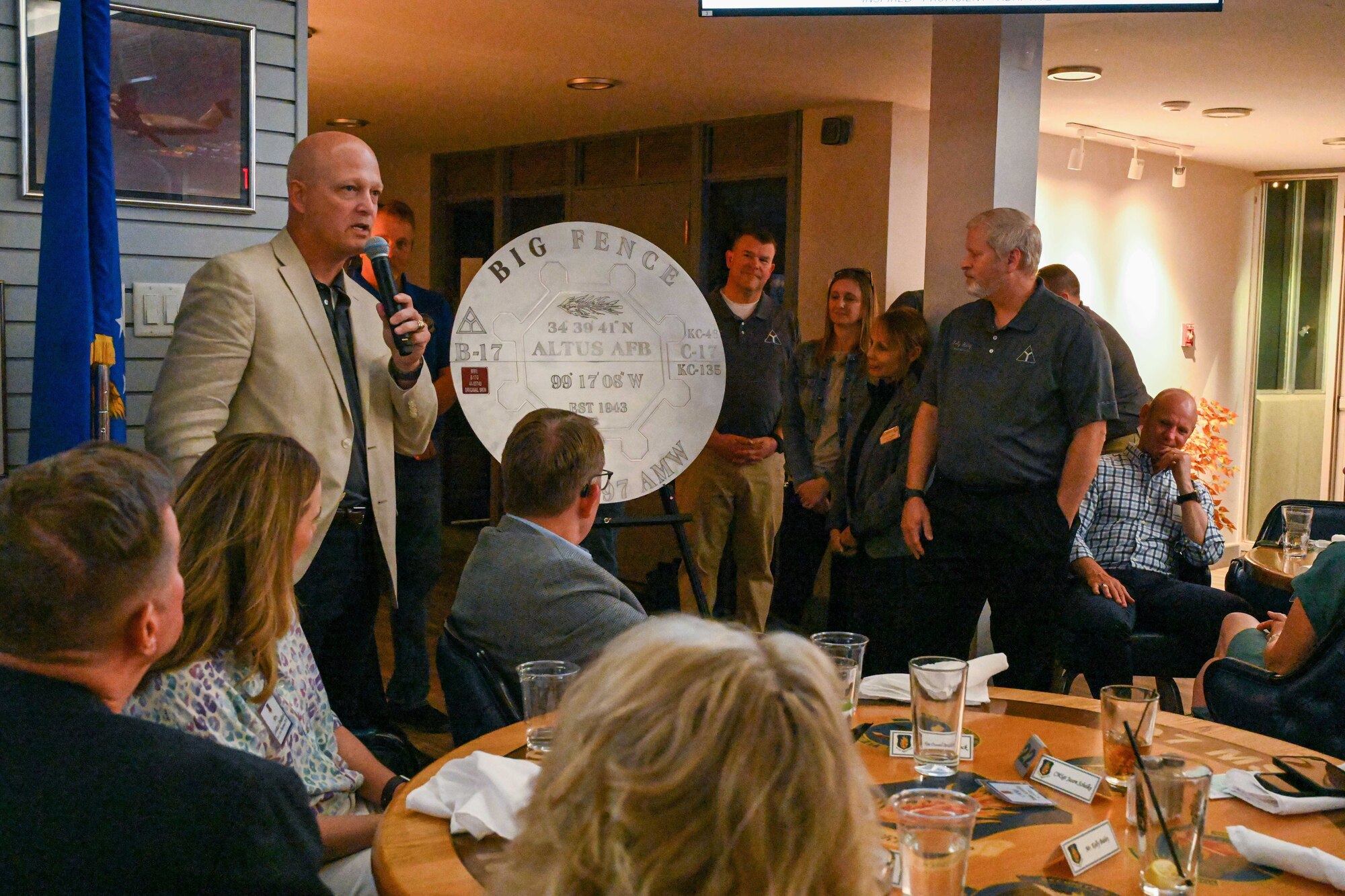 Col. Blaine Baker, 97th Air Mobility Wing commander, reveals a replica of a navigational aid used by the 97th Bombardment Group during WWII at Charlie’s Lounge, at Altus Air Force Base, Oklahoma, April 13, 2023. During the event, Charlie’s was recognized as a historical marker in honor of “Big Fence”, a navigational aid call sign used during World War II to guide aircraft and aircrews to safety. (U.S. Air Force photo by Airman 1st Class Miyah Gray)