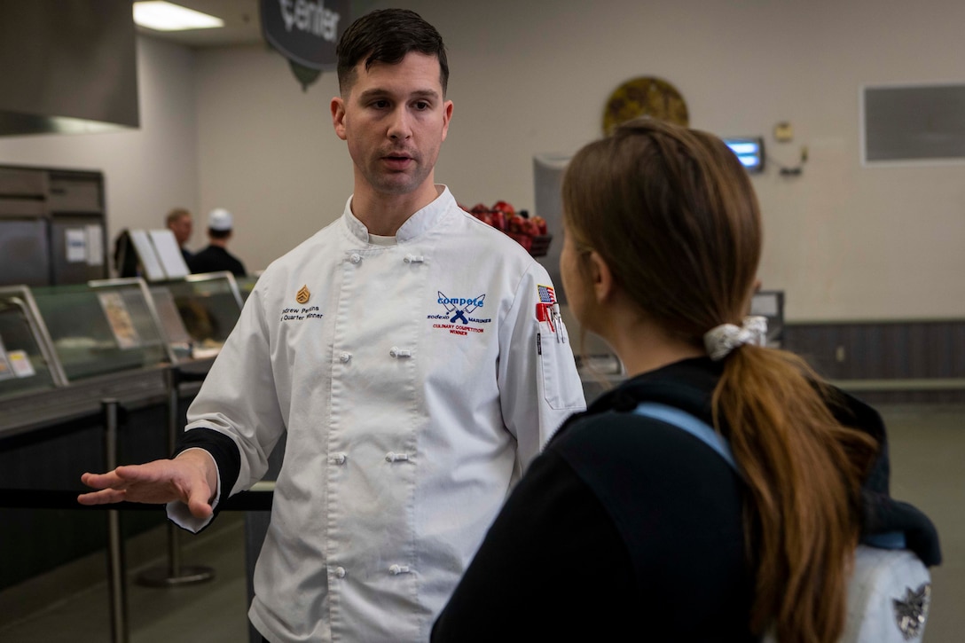 U.S. Marine Corps Staff Sgt. Andrew Perkins, Chief Cook, Phelps Chow Hall, Marine Corps Air Ground Combat Center (MCAGCC), speaks with a student during a Morongo Unified School District Job Shadow event at MCAGCC