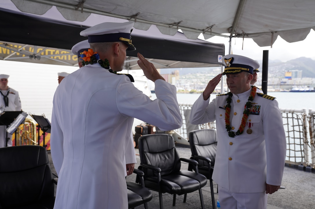 Capt. Stephen Adler and Capt. Brian Krautler salute during a change of command ceremony held aboard the U.S. Coast Guard Cutter Stratton (WMSL 752) at Base Honolulu, April 17, 2023. Adler was relieved by Krautler before departing for a new assignment in Washington, D.C. (U.S. Coast Guard photo)