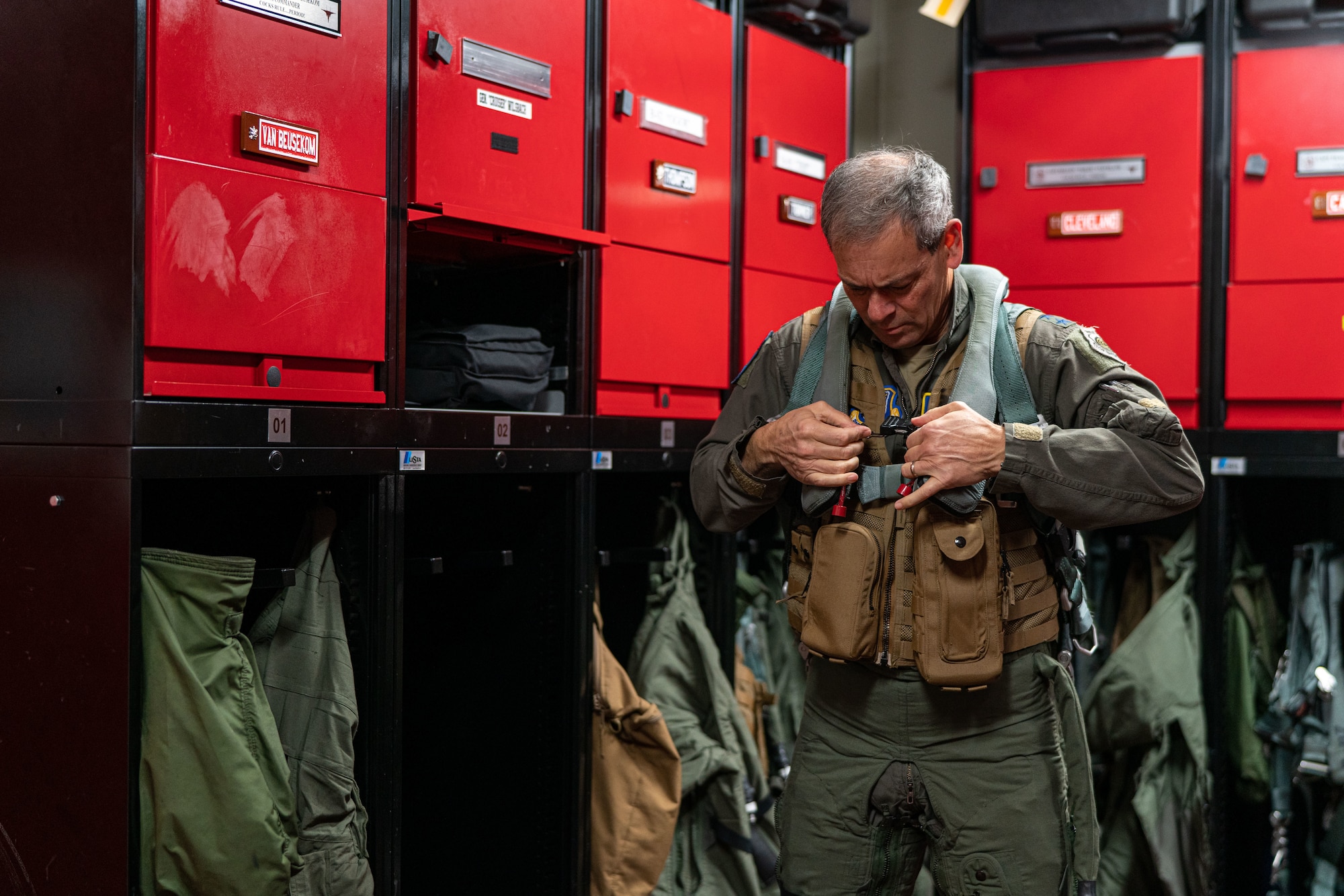 An Airman puts on a flight suit before a flight.