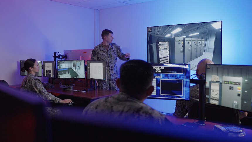 DAHLGREN, Va. (Oct. 06, 2021) Surface Combat Systems Training Command (SCSTC) AEGIS Training and Readiness Center (ATRC) Instructor Fire Controlman (Aegis) 1st Class Kirt Palmer demonstrates to his students how to execute maintenance and troubleshooting procedures using the Aegis Virtual Maintenance Trainer (VMT), a high-fidelity 3D training simulation.  The VMT provides a virtual representation of the entire Aegis Weapon System computer network.  It was developed, funded and delivered as part of the Director, Surface Warfare’s, OPNAV N96, program of record, Surface Training Advanced Virtual Environment-Combat Systems (STAVE-CS).  (Photo courtesy of Metro Productions)