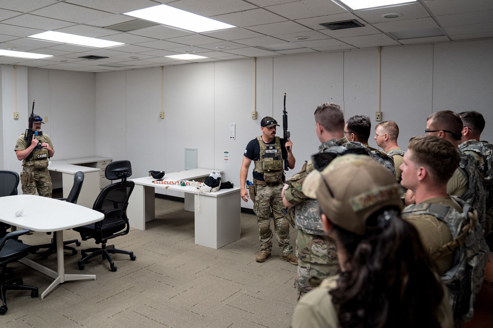U.S. Air Force Staff Sgt. Michael Dazzo, 5th Combat Communications Support Squadron Combat Readiness lead instructor, gives directions to members of the 85th Engineering Installation Squadron on close quarter battle tactics during a MOB school course at Keesler Air Force Base, Mississippi, April 12, 2023. In this course 85th EIS students learn weapons familiarization, combatives and other pre-deployment tactics.