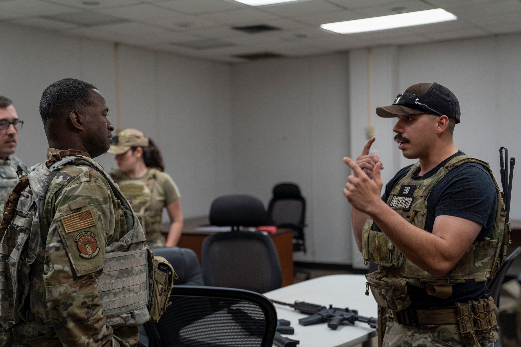U.S. Air Force Staff Sgt. Michael Dazzo, 5th Combat Communications Support Squadron Combat Readiness lead instructor, educates members of the 85th Engineering Installation Squadron on close quarter battle tactics during a MOB school course at Keesler Air Force Base, Mississippi, April 12, 2023. In this course 85th EIS students learn weapons familiarization, combatives and other pre-deployment tactics.