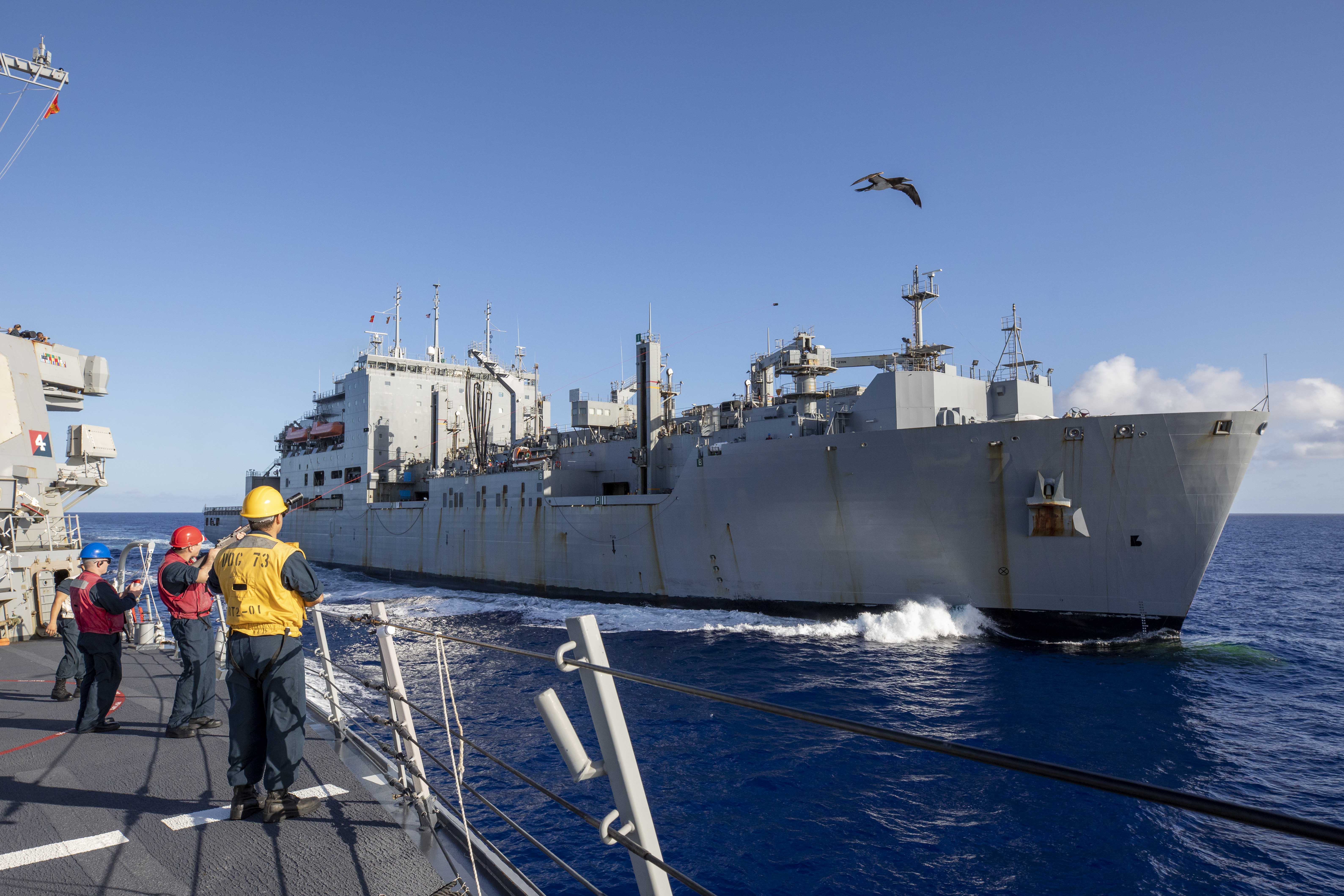 U.S. Navy Sailors participate in a replenishment-at-sea with the fleet dry cargo and ammunition ship USNS Carl Brashear (T-AKE 7) aboard the Arleigh Burke-class guided-missile destroyer USS Decatur (DDG 73).