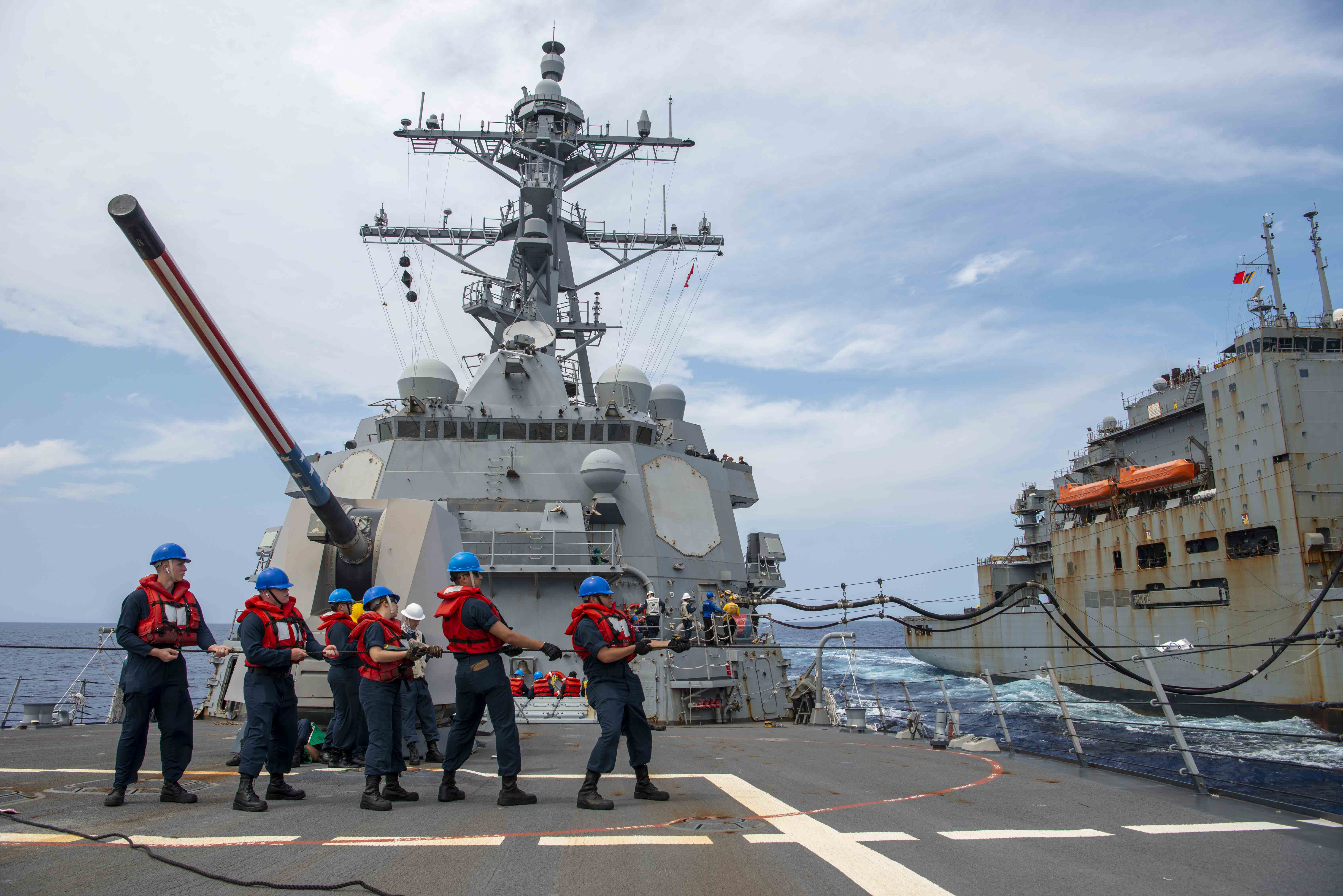 U.S. Navy Sailors aboard the Arleigh Burke-class guided-missile destroyer USS Wayne E. Meyer (DDG 108) conduct an underway replenishment with the Lewis and Clark-class dry cargo ship USNS Washington Chambers (T-AKE 11).