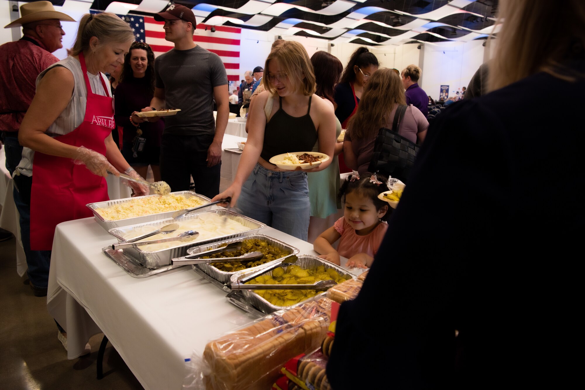 Military families are served food at the World’s Largest BBQ hosted at the Abilene Convention Center in Abilene, Texas, April 15, 2023. The Abilene Military Affairs Committee hosted the 58th Annual World’s Largest BBQ honoring military personnel and their service. (U.S. Air Force photo by Airman 1st Class Alondra Cristobal Hernandez)