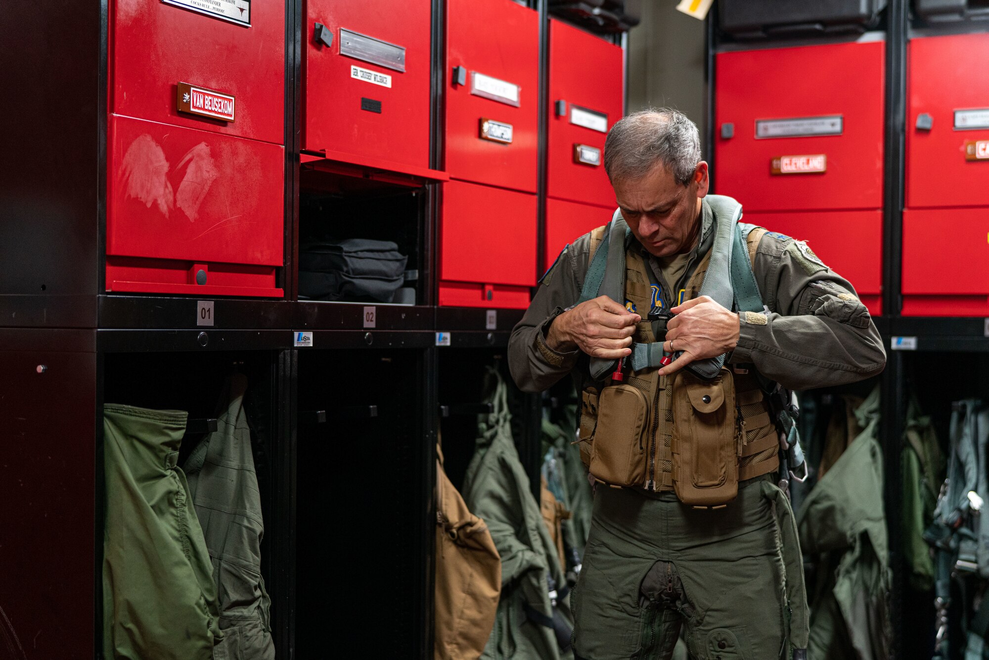 An Airman puts on a flight suit before a flight.