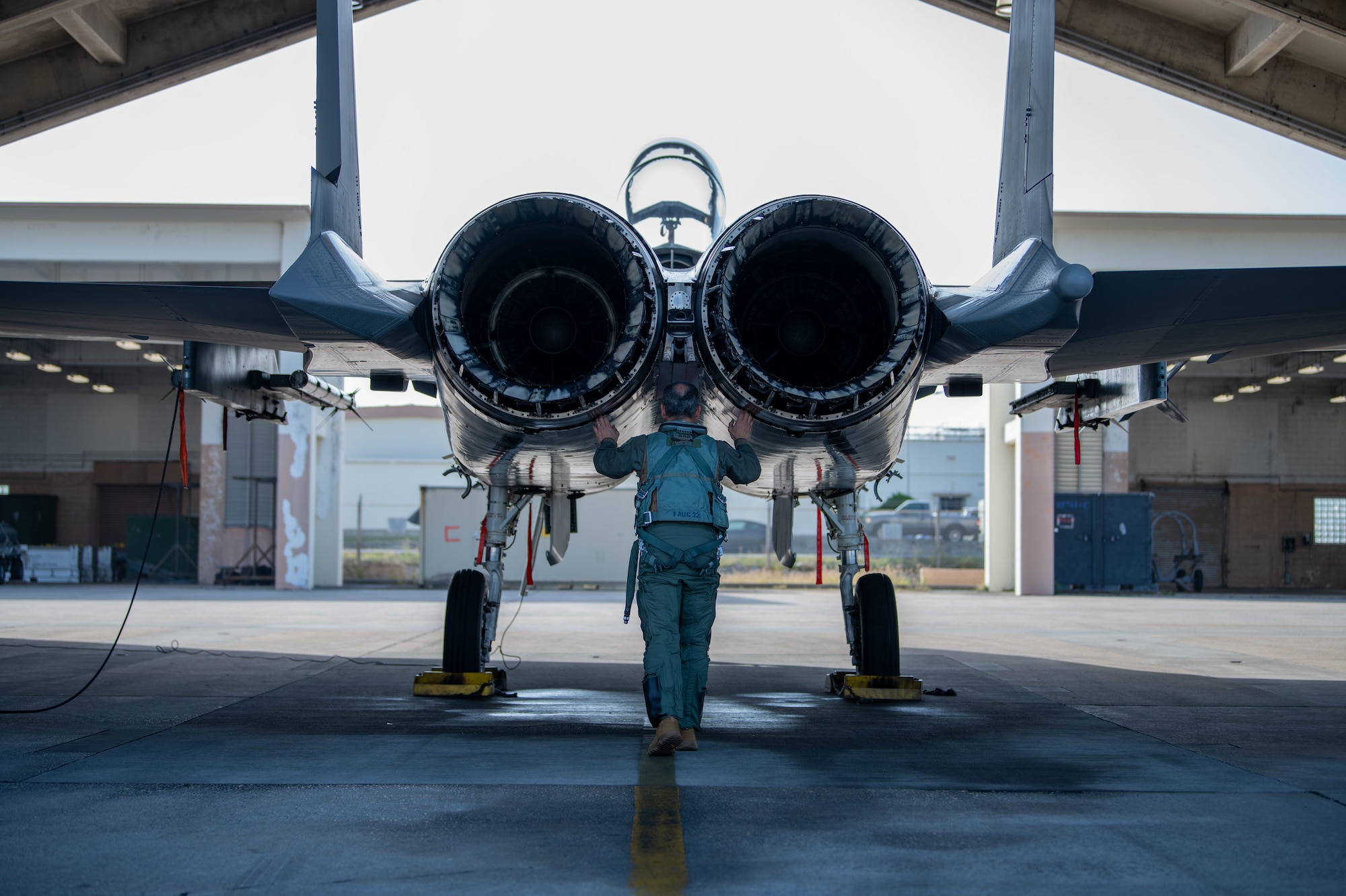 An Airman checks a jet before a flight.