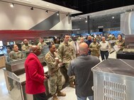 Attendees gather around Massaro in ventless kitchen area