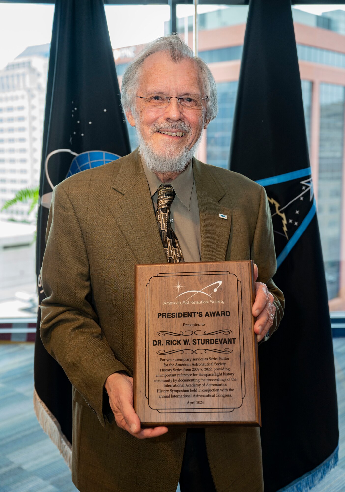 Dr. Rick Sturdevant, Space Training and Readiness Command historian, poses for a photo following a ceremony where he was  presented the American Astronautical Society President's Award for his work as series editor for the International Academy of Astronautics History at STARCOM Headquarters