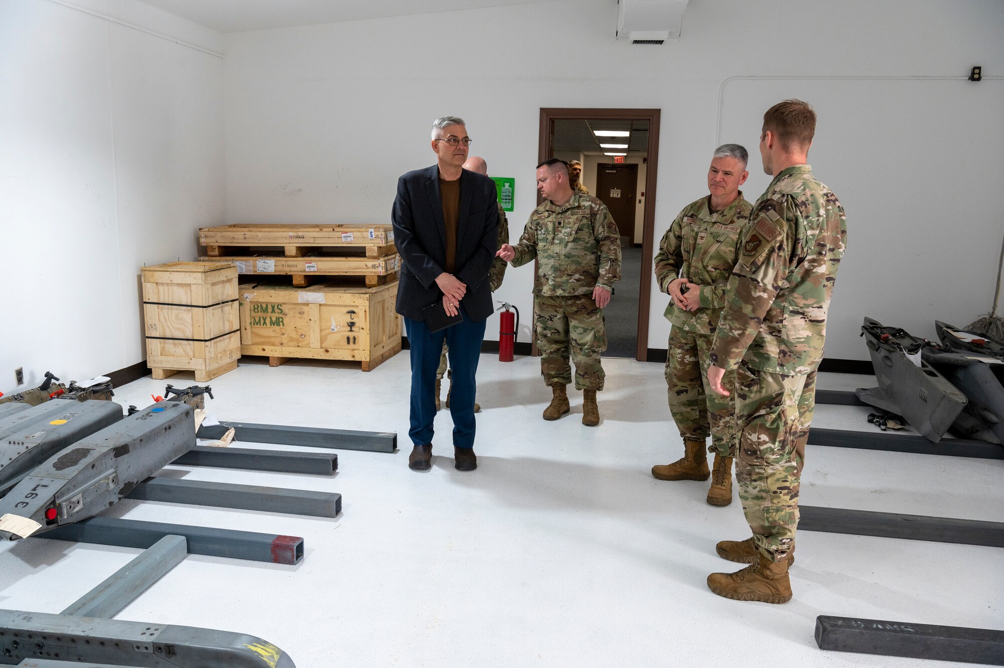U.S. Air Force Lt. Col. Scott Kubalek, 51st Munitions Squadron commander, right, gives Col. Todd Wydra, 51st Maintenance Group commander, middle, a tour of the newly renovated MUNS facility at Osan Air Base, Republic of Korea, April 12, 2023. Rather than demolishing and rebuilding, renovating the space saved the Air Force both time and money, while also allowing the workspace to be ready within the timeframe required for the mission. (U.S. Air Force Photo by Airman 1st Class Aaron Edwards)
