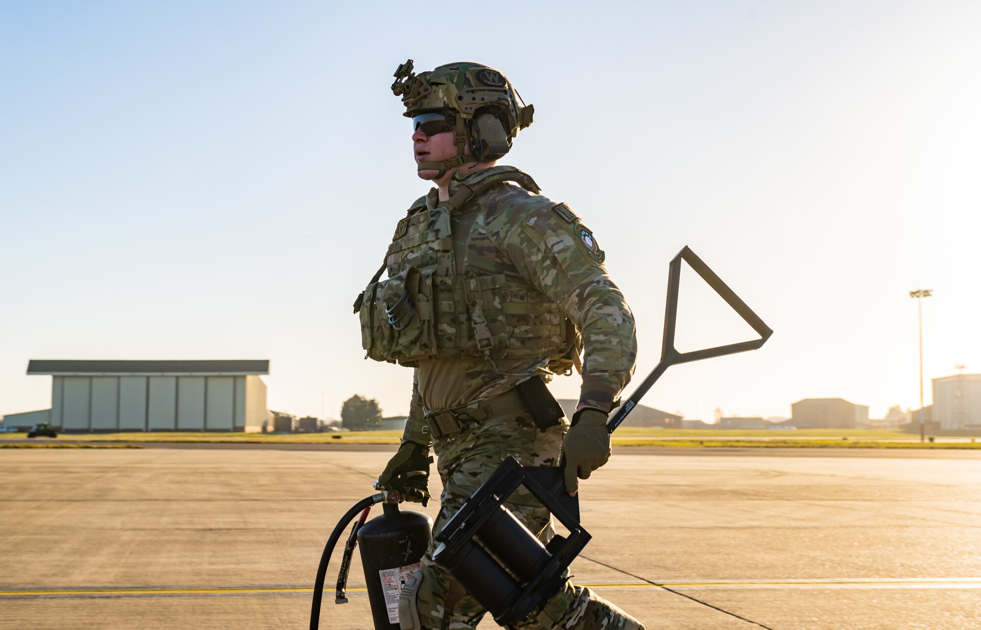 U.S. Air Force Senior Airman Benjamin Kramer, 100th Logistics Readiness Squadron forward area refueling point (FARP) specialist assigned to the 100th Air Refueling Wing, carries gear across the flight line during FARP training at Royal Air Force Mildenhall, England, Feb. 6, 2023. Only select Airmen within the petroleum, oil, and lubricants career field are trained to perform FARP duties, as it requires both mental and physical strength to execute the no-fail mission. (U.S. Air Force photo by Staff Sgt. Kevin Long)